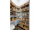 Organized pantry with custom wood bins for storage; a chef's dream come true at 33176 Whisper Pointe Dr, Wesley Chapel, FL 33545