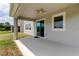 Covered patio with ceiling fan, sliding glass door, and a view of the backyard at 33176 Whisper Pointe Dr, Wesley Chapel, FL 33545