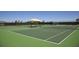 A well-maintained tennis court with shaded seating, perfect for friendly matches and skill-building at 33176 Whisper Pointe Dr, Wesley Chapel, FL 33545
