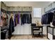 Organized walk-in closet with custom shelving, ample storage space, vanity table, and natural light at 33176 Whisper Pointe Dr, Wesley Chapel, FL 33545