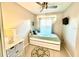 Bedroom with a ceiling fan and art on the wall at 3400 Gulf Blvd # 102, Belleair Beach, FL 33786
