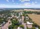 Aerial shot of a quaint neighborhood featuring scenic landscaping, trees, and a serene body of water in the distance at 36846 Jefferson Ave, Dade City, FL 33523