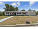 Charming one-story home with painted brick, black trim, and a well-manicured lawn at 36846 Jefferson Ave, Dade City, FL 33523