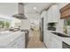 Modern white kitchen with stainless steel appliances, a breakfast bar, and natural light at 36846 Jefferson Ave, Dade City, FL 33523