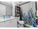 Bathroom with a white vanity, decorative shower curtain, and modern fixtures at 3709 Greenery Ct # 209, Tampa, FL 33618