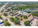 Community aerial showcases its buildings and community pool by a tranquil lake setting at 3824 Cortez Dr # B, Tampa, FL 33614