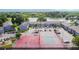 Aerial shot featuring tennis court, playground, and lakeside apartments with nearby parking at 3824 Cortez Dr # B, Tampa, FL 33614