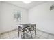 Well-lit dining area featuring tile floors, a window, and seating for two at 3824 Cortez Dr # B, Tampa, FL 33614
