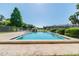 Community pool area with lounge chairs, well-maintained landscaping, and community buildings at 3824 Cortez Dr # B, Tampa, FL 33614