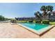Community pool featuring lake views, palm trees, and lounge area at 3824 Cortez Dr # B, Tampa, FL 33614