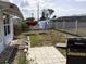 Spacious backyard featuring a grill, patio area, and a clothesline, great for outdoor relaxation and activities at 3850 Sablewood Dr, Holiday, FL 34691