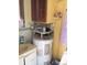 Compact bathroom featuring a sink, vanity, and built-in shelving above the water heater at 3850 Sablewood Dr, Holiday, FL 34691