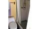 Bathroom with white-tiled shower behind shower curtain, along with a standard toilet and neutral-colored walls at 3850 Sablewood Dr, Holiday, FL 34691