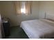 Bedroom with neutral walls, carpet, and window with curtain letting in natural light at 3850 Sablewood Dr, Holiday, FL 34691