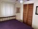Bedroom featuring closet with wood doors, window, and neutral colored walls at 3850 Sablewood Dr, Holiday, FL 34691