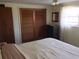 Serene bedroom with wood-paneled closet doors and a window that lets in soft, natural light at 3850 Sablewood Dr, Holiday, FL 34691