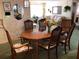 Traditional dining room with wood table, chairs, and bright natural light at 3850 Sablewood Dr, Holiday, FL 34691