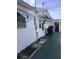 Exterior of a home with white walls, awnings, and an air conditioning unit at 3850 Sablewood Dr, Holiday, FL 34691