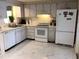 Traditional kitchen featuring white appliances, ample cabinet space and neutral countertops at 3850 Sablewood Dr, Holiday, FL 34691