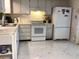 Traditional kitchen featuring white appliances, ample cabinet space and neutral countertops at 3850 Sablewood Dr, Holiday, FL 34691