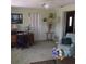 Comfortable living room showcasing a desk area, accent chair, and lush green carpeting at 3850 Sablewood Dr, Holiday, FL 34691