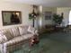 Inviting living room featuring a sofa, armchairs, glass-topped table and mirror at 3850 Sablewood Dr, Holiday, FL 34691