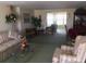 Cozy living room with armchairs, sofa, and sliding glass doors to the outdoors at 3850 Sablewood Dr, Holiday, FL 34691