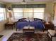 Cozy living area featuring a daybed with decorative pillows, tile flooring, and side tables at 3850 Sablewood Dr, Holiday, FL 34691