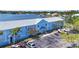 Aerial shot of the building with ample parking and lush landscaping, near a scenic waterfront at 5003 Starfish Dr Se # B, St Petersburg, FL 33705