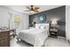 Stylish bedroom features a decorative ceiling fan, accent wall, and neutral decor at 5003 Starfish Dr Se # B, St Petersburg, FL 33705