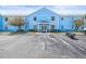 Inviting condo complex featuring charming blue facade, well-maintained landscaping and ample parking at 5003 Starfish Dr Se # B, St Petersburg, FL 33705