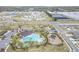 Aerial view of community amenities including a pool, playground, and well-planned streets at 5059 Bromeliad Ave, Wimauma, FL 33598