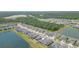 Aerial view of the property and the surrounding community with lush green spaces and ponds at 5059 Bromeliad Ave, Wimauma, FL 33598