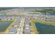 Aerial view of the property and the surrounding community, showing many houses and ponds at 5059 Bromeliad Ave, Wimauma, FL 33598