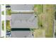 Aerial view shows the roof of the property, the surrounding yards, and the neighboring houses at 5059 Bromeliad Ave, Wimauma, FL 33598