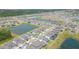 Wide aerial view showcasing a neighborhood with multiple lakes and green spaces at 5059 Bromeliad Ave, Wimauma, FL 33598