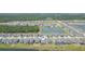 Aerial view of the property and the surrounding community with ponds on both sides of the street at 5059 Bromeliad Ave, Wimauma, FL 33598