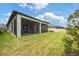 Well-maintained backyard with a screened-in lanai and lush landscaping offers a private outdoor retreat at 5059 Bromeliad Ave, Wimauma, FL 33598