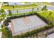 Community basketball court featuring a full court, benches, and surrounded by a security fence and landscaping at 5059 Bromeliad Ave, Wimauma, FL 33598