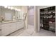 Well-lit bathroom features a double sink vanity with granite counters and a glass-enclosed shower at 5059 Bromeliad Ave, Wimauma, FL 33598