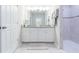 Modern bathroom featuring double vanity with granite counters, tile floors, and a glass-enclosed shower at 5059 Bromeliad Ave, Wimauma, FL 33598