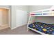 Cozy bedroom with a bunk bed, carpet flooring, and a closet for storage at 5059 Bromeliad Ave, Wimauma, FL 33598