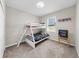 Bright bedroom featuring a bunk bed, neutral walls, and cozy carpeting at 5059 Bromeliad Ave, Wimauma, FL 33598