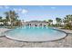 Large community pool with ample deck space, palm trees, and covered seating areas at 5059 Bromeliad Ave, Wimauma, FL 33598