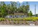 Elegant Berry Bay community sign with decorative plants, trees, and geese sculpture at 5059 Bromeliad Ave, Wimauma, FL 33598