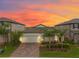 Charming single-Gathering home with a two-car garage, paver driveway, and lush landscaping at 5059 Bromeliad Ave, Wimauma, FL 33598