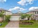 Exterior home view showcasing a stunning view, paver driveway, and manicured lawn at 5059 Bromeliad Ave, Wimauma, FL 33598
