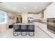 Modern kitchen with stainless steel appliances, granite countertops, and a large island with seating at 5059 Bromeliad Ave, Wimauma, FL 33598