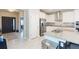 Spacious kitchen featuring white cabinets, stainless steel appliances, granite countertops, and a large island at 5059 Bromeliad Ave, Wimauma, FL 33598