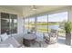 Relaxing screened lanai with comfortable seating and a view of the serene community lake at 5059 Bromeliad Ave, Wimauma, FL 33598